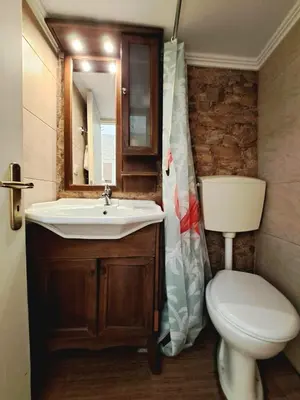a bathroom with a sink and a toilet and a mirror at Center studio 25 in Chania Town