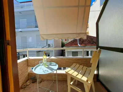 a glass table and a chair on a balcony at Center studio 25 in Chania Town