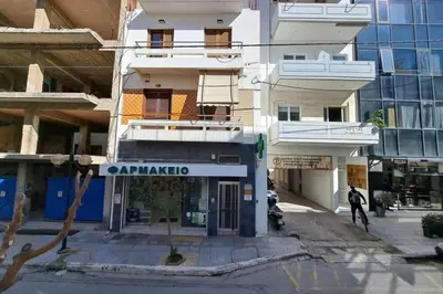 a building with a sign that reads amphipolis at Center studio 25 in Chania Town