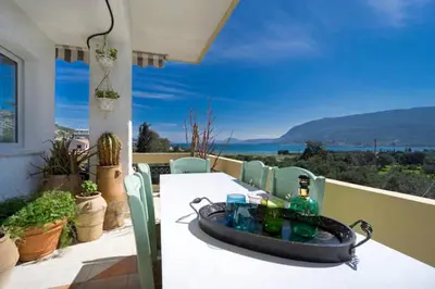 a table on a balcony with a sink on it at Penthhouse next to the beach in Souda