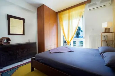a bedroom with a large bed and a window at Penthhouse next to the beach in Souda