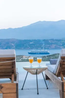 two glasses of orange juice sitting on a table on a patio at Fantasea Villas, villa Lux in Galangádhos