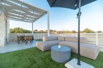 a living room with a couch and a table at Fantasea Villas, villa Lux in Galangádhos