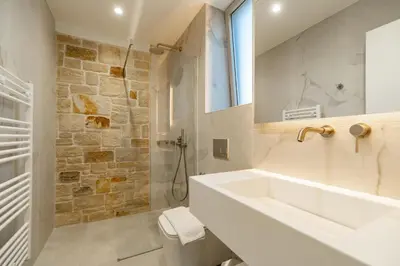 a white bathroom with a sink and a mirror at Fantasea Villas, villa Lux in Galangádhos