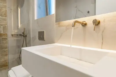 a white bathroom with a tub and a sink at Fantasea Villas, villa Lux in Galangádhos