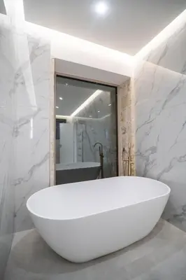 a white bath tub in a bathroom with marble walls at Fantasea Villas, villa Lux in Galangádhos