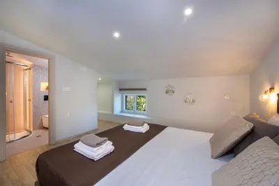 a bedroom with a large bed with towels on it at Casa di Mina's in Chania in Sirílion