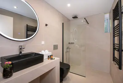 a bathroom with a sink and a shower at Casa di Mina's in Chania in Sirílion