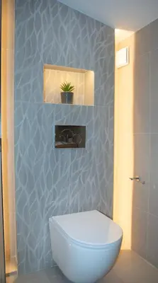 a bathroom with a toilet and a plant on the wall at Casa di Mina's in Chania in Sirílion