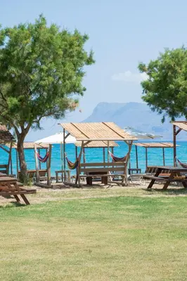 a group of picnic tables with a view of the ocean at Naya in Kissamos