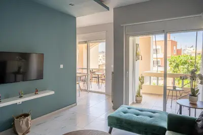 a living room with a couch and a tv at Tessera Alfa city apartment in Chania Town