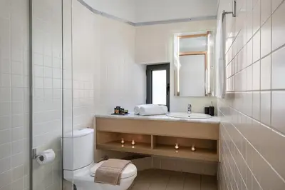 a bathroom with a sink and a toilet and a mirror at Villa AnnaNiko, Luxury Villa, 2 Heated Pools, Jacuzzi, Gym, Stunning Views, Green Energy in Gerani Chanion