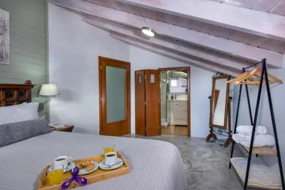 a bedroom with a bed with a tray of food on it at Villa Splantzia - Heated pool - Garden in Chania Town