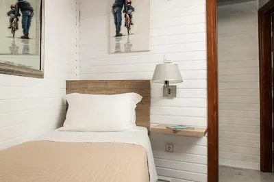 a bedroom with white walls and a bed with a lamp at Villa Splantzia - Heated pool - Garden in Chania Town