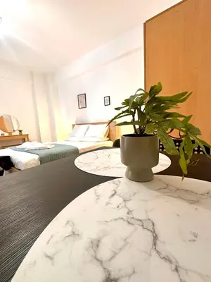 a potted plant sitting on a table in a bedroom at Kd's apartment B in Chania Town