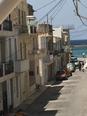 a street with buildings and cars parked on the side at Kd's apartment B in Chania Town