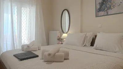 a bedroom with a white bed with towels on it at Melina's House in Chania Town