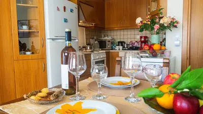 a kitchen with a table with wine glasses on it at Melina's House in Chania Town