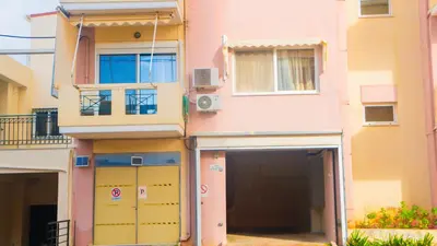 a building with two garage doors in front of it at Melina's House in Chania Town