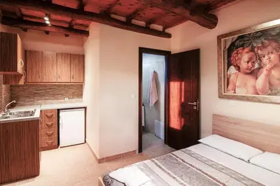 a kitchen with a bed and a painting on the wall at Beautiful Villa in Zounákion