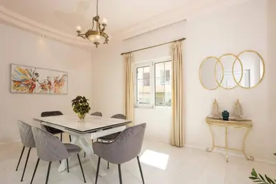 a dining room with a table and chairs at The White Marble Luxury City Apt in Chania Town