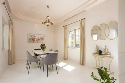 a dining room with a table and chairs at The White Marble Luxury City Apt in Chania Town