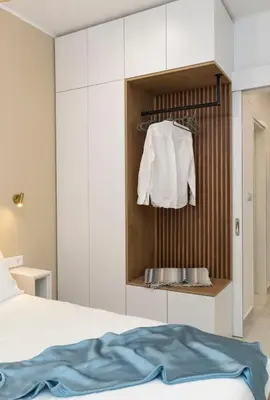 a bedroom with a bed and white cabinets at Alma & Nina Apt in Chania Town