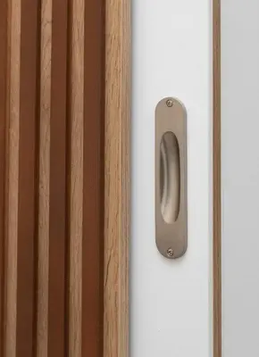 a metal door handle on a white wall at Alma & Nina Apt in Chania Town