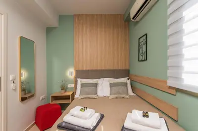 a bedroom with a bed with towels on it at Olive Chrysi Luxury Villa with in-room plunge pool in Chania Town
