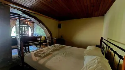 a bedroom with a bed in a room at Diving into silence - Traditional Stone House in Kakópetros
