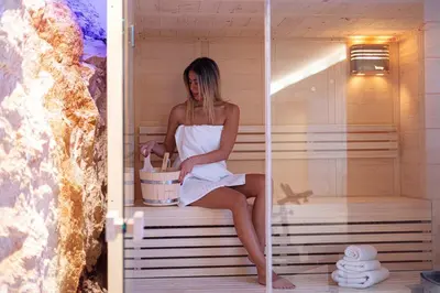 a woman is sitting in a sauna at Villa Mika in Chania Town