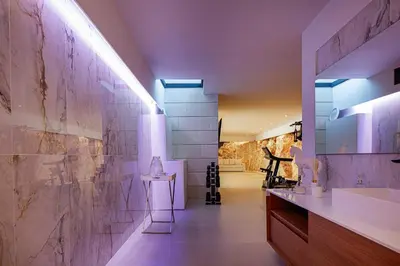 a bathroom with a sink and a wall with tiles at Villa Mika in Chania Town