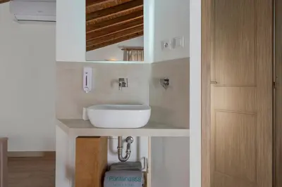 a bathroom with a white sink on a counter at Pantanassa Villas in Agia Marina Nea Kydonias