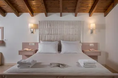 a bedroom with a bed with two towels on it at Pantanassa Villas in Agia Marina Nea Kydonias