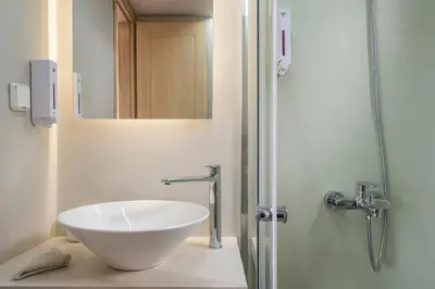 a bathroom with a white bowl sink on a counter at Pantanassa Villas in Agia Marina Nea Kydonias