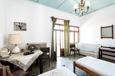 a room with a bedroom with a bed and a table at Three Bedroom Apartment in City Center with Sea View near the Beach in Kissamos