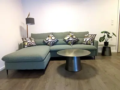 a living room with a green couch and a table at Casa Dina Nea Chora in Chania Town