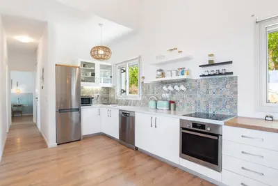 a kitchen with white cabinets and stainless steel appliances at Villa Helissie in Vamos