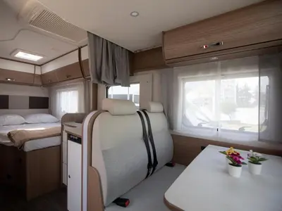 a small caravan with a bed and a table at CamperLifeCrete in Chania Town