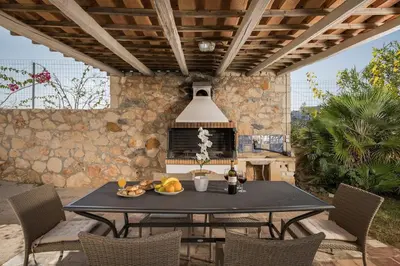 a table with a plate of fruit on a patio at Tersanas Sea Front Villas in Tersanas