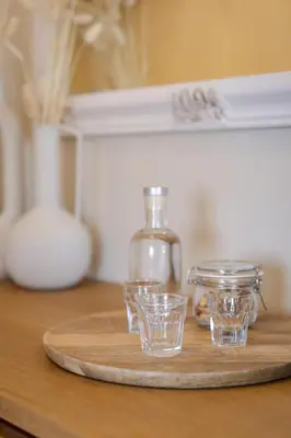 a tray with four glasses and a bottle on a table at Elirion Luxury Home II in Kamária