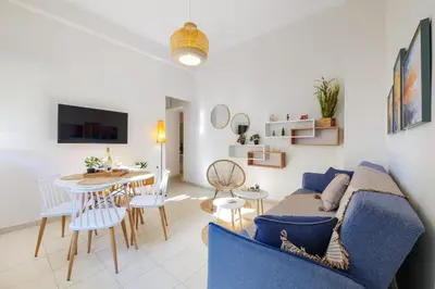 a living room with a blue couch and a table at Elartis Apartment in Chania Town