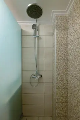 a shower with a shower head in a bathroom at Elartis Apartment in Chania Town