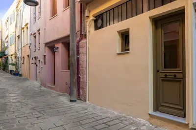 an alley in an old town with a door at Elartis Apartment in Chania Town