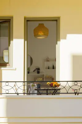 a balcony with a table and a dining room at Elartis Apartment in Chania Town
