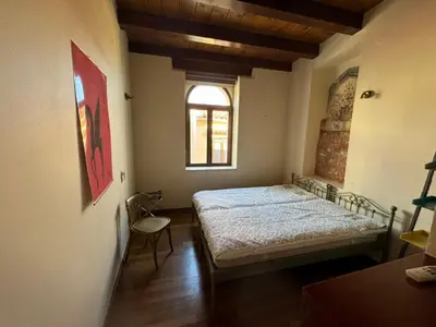 a bedroom with a bed and a window at Casa Argirenia - Venetian Mansion in Old Harbour in Chania Town