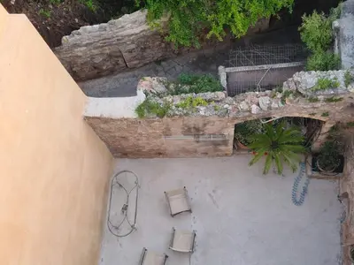 an overhead view of a patio with benches and plants at Casa Argirenia - Venetian Mansion in Old Harbour in Chania Town