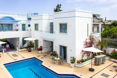 a villa with a swimming pool and a house at Blue Calm in Daratso