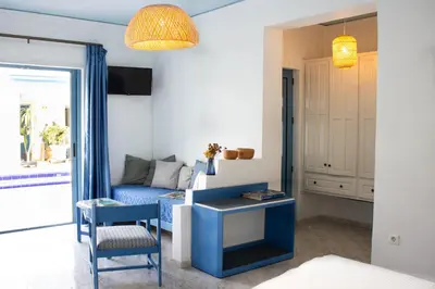 a living room with a blue couch and a chair at Blue Calm in Daratso