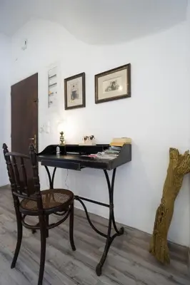a desk in a room with a chair next to a wall at Superior Apartment Near Beach in Chania Town